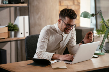 Businessman working in the office on his laptop. Stylish businessman working on a project in the office.