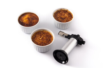 Homemade creme brulee in bowl isolated on white background