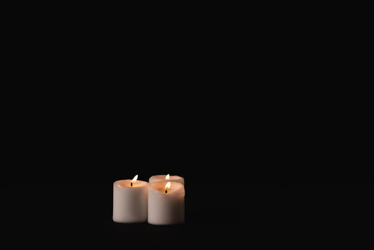 burning candles on black background, funeral concept, stock image
