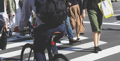 Blurry people crossing in the busy street of the metropolis, Busy city street crossing with many pedestrians.