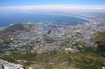 Fototapeta premium View from Table Mountain to Cape Town, South Africa. Foot of Table Mountain, bird's eye view of the city, city skyline, bay, ocean in the background.
