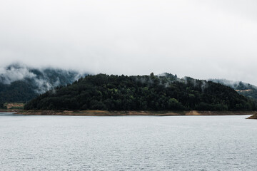 Foggy morning on the mountain lake