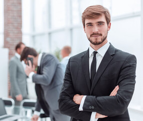 Fototapeta premium confident young businessman standing in the office