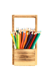 Many colourful drawing pencils in a wooden basket, isolated on white
