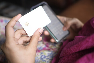  women hand holding credit card and using smart phone shopping online 