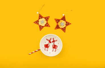 Christmas composition, plate with a deer and decorative stars form of a face, funny, orange background template top view