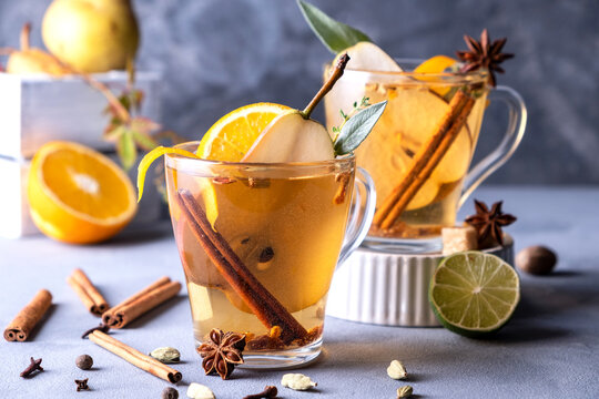 Spicy Warm Beverage. Seasonal Mulled Drink..Christmas Hot White Mulled Wine In Glass With Orange