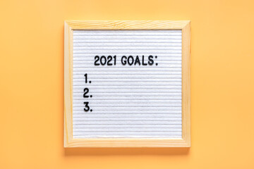 felt board with text - 2021 goals isolated on yellow background Planning, self motivation, achievement, success, wish list, checklist concept Top view Flat lay Motivational quote, message