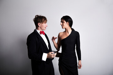 Portrait of a young elegant couple. Elegant dress. Couple in love. Model. Photo studio. Fun. 
