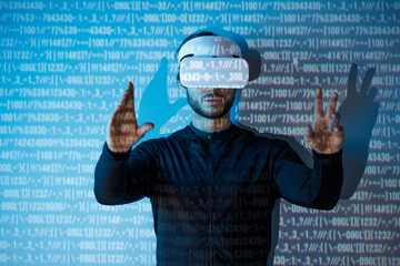 Young man in futuristic costume on blue neon light digital interface background. Guy using VR...