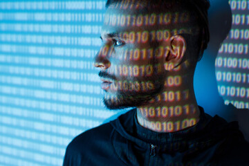 Portrait of hacker man on blue neon light digital interface background. Internet, technology, cyber...