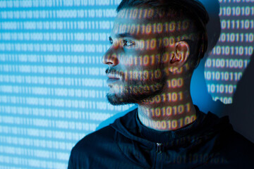 Portrait of hacker man on blue neon light digital interface background. Internet, technology, cyber...