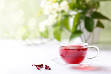 Healthy hibiscus tea in transparent cup