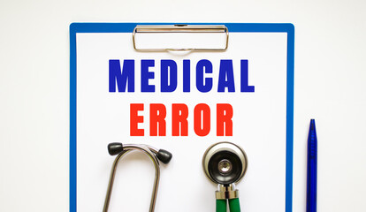 Clipboard with page and text MEDICAL ERROR, on a table with a stethoscope and pen.