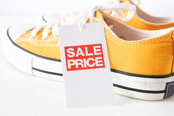  yellow shoes with red label sale on white background