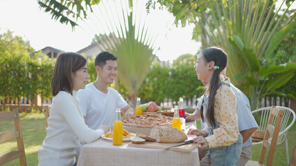 Asian family celebration pizza party outside in the backyard