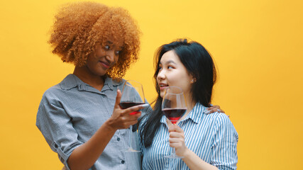 Cheers. Two young multiethnic friends, toasting with wine glasses. Best friends and celebration. High quality photo