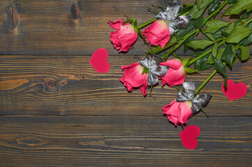 Pink roses on a wooden background, a table. View from above. The concept of a floral background, Valentine's day