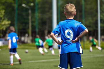 Children on Sports Field. Kids Kicking Football Match. Soccer Tournament Game For School Age Children