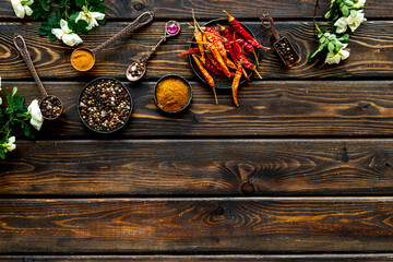 Set of various hot spices and herbs in a bowls. Top view, copy space.