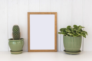 Mock up white frame and dry twigs in vase on book shelf or desk. White colors.