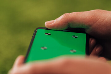 Girl Holds An New Smart Phone In Her Hand. Chroma Key Green