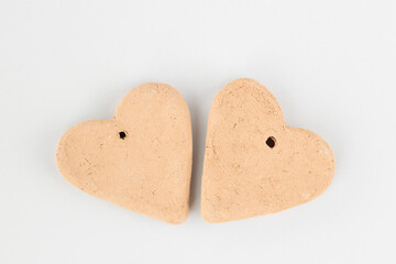 Two hearts made of clay on a gray background. DIY concept. Symbol of love, fidelity, passion. Copy space. Minimal concept. Close-up. Top view. 