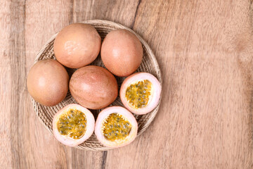 Fresh passion fruit in a basket on wooden background, Tropical fruit, Top view