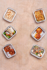 take away lunch boxes with fresh meal in foil container or healthy food delivery