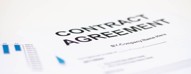 The contract paper is waiting for the director's signature on the desk in the office.
