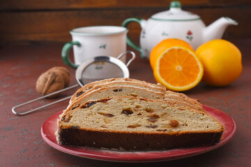 Christmas Stollen - homemade cake with sweet dried fruits,  raisins, orange pieces for lunch with black tea