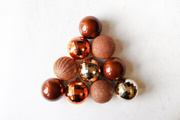 Christmas design triangle from golden balls on white background