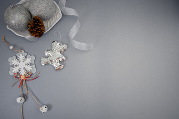 Flat lay pf silver glitter Christmas ornaments on a gray surface - perfect for wallpaper