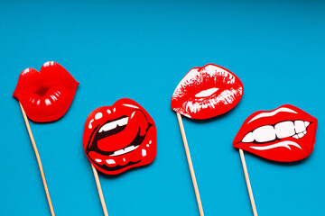 red attractive female lips on a blue bright background