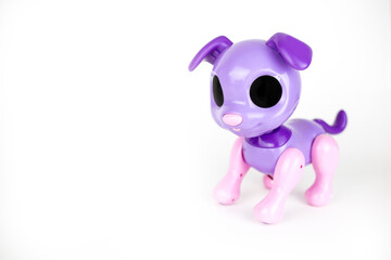 Isolated pink mechanical toy dog stands on a white background. Place for text