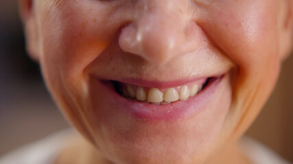 Close up portrait of cheerful mature woman smiling at camera