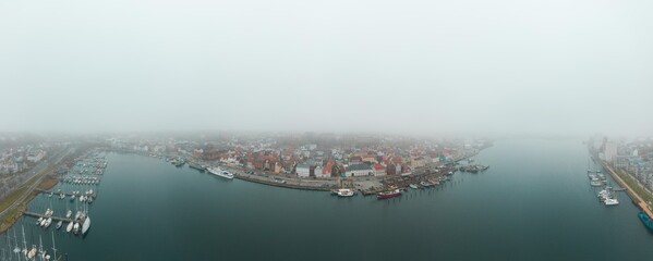 Drone aerial panorama of Flensburg Germany foggy mood