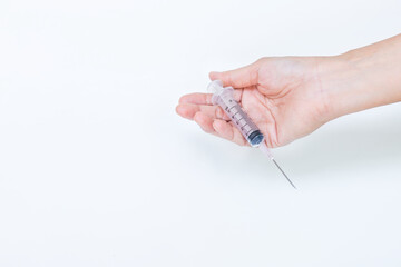 New syringe in girl hand isolate on white background, hand holding syringe without medical gloves, medical and health care concept 