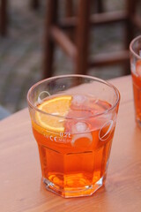 a glass with a drink, aperol, spritz, a drink based on bitter oranges