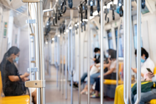 The Environment of Asia passengers inside the Sky Train with the masks on all people's faces.