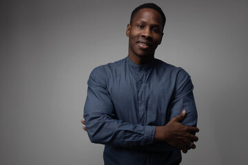 Obraz premium A handsome confident cheerful male entrepreneur has a wide smile, is happy to meet a colleague, and is dressed in a fashionable shirt isolated on a gray and white background