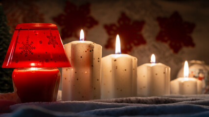 bright yellow decorative candle with christmas globes