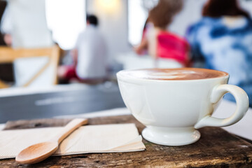 Fototapeta na wymiar Hot latte art aroma coffee on wood table