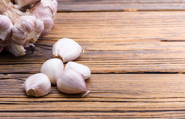 Fresh garlic on a vintage table With peeled and bunched garlic together