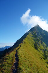 Cloudy sunrise ridge view from the Augstmatthorn in the Bernese Oberland. Overlooking the scenery of lake Brienz, Brienzersee, Emmental Alps, Switzerland