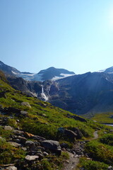 Waterfall flowing to the Reservoir Mooserboden embedded in the impressive mountains of the Hohe Tauern near Kaprun, Austria.
