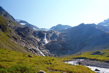 Waterfall flowing to the Reservoir Mooserboden embedded in the impressive mountains of the Hohe Tauern near Kaprun, Austria.