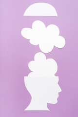 top view of paper human head and clouds on violet 
