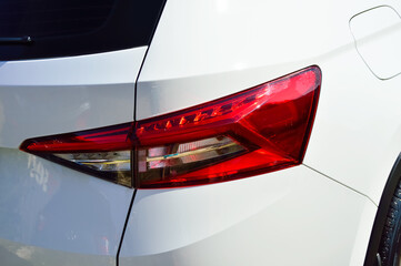 close-up - red headlight of a white car, rear view