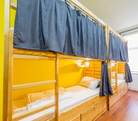 Hostel dormitory beds arranged in room